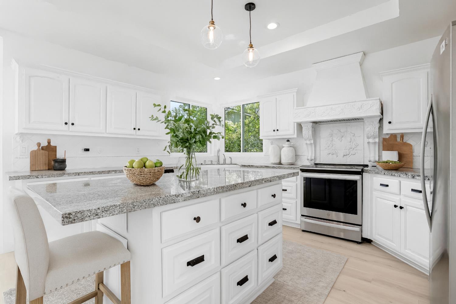 3740 North Lakeshore Boulevard Loomis, CA 95650 - Photo 14 of 67 Digitally altered and virtually staged kitchen with white cabinets, appliances with stainless steel finishes, light stone counters, and recessed lighting