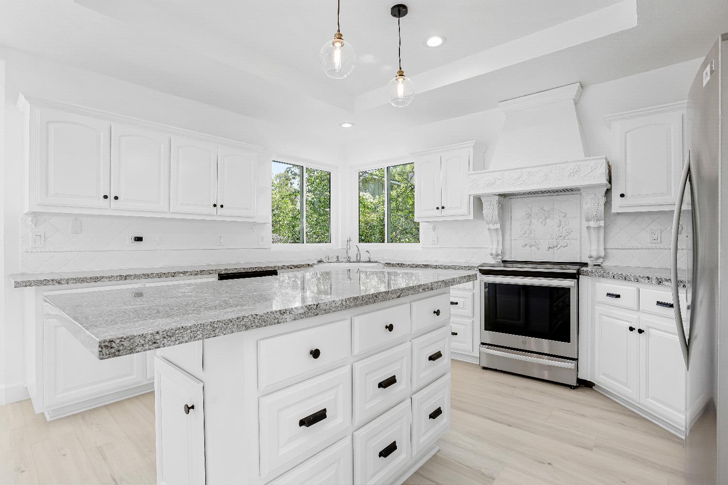 3740 North Lakeshore Boulevard Loomis, CA 95650 - Photo 16 of 67 Unstaged kitchen with white cabinets, appliances with stainless steel finishes, light stone counters, and recessed lighting