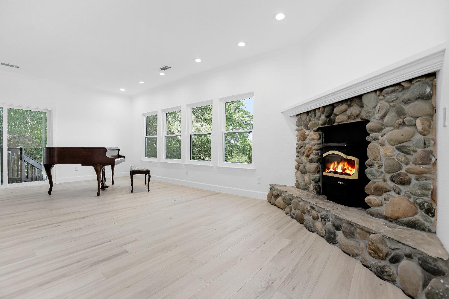 3740 North Lakeshore Boulevard Loomis, CA 95650 - Photo 7 of 67 Digitally altered and virtually staged living area with recessed lighting, light wood finished floors, plenty of natural light, and a stone fireplace