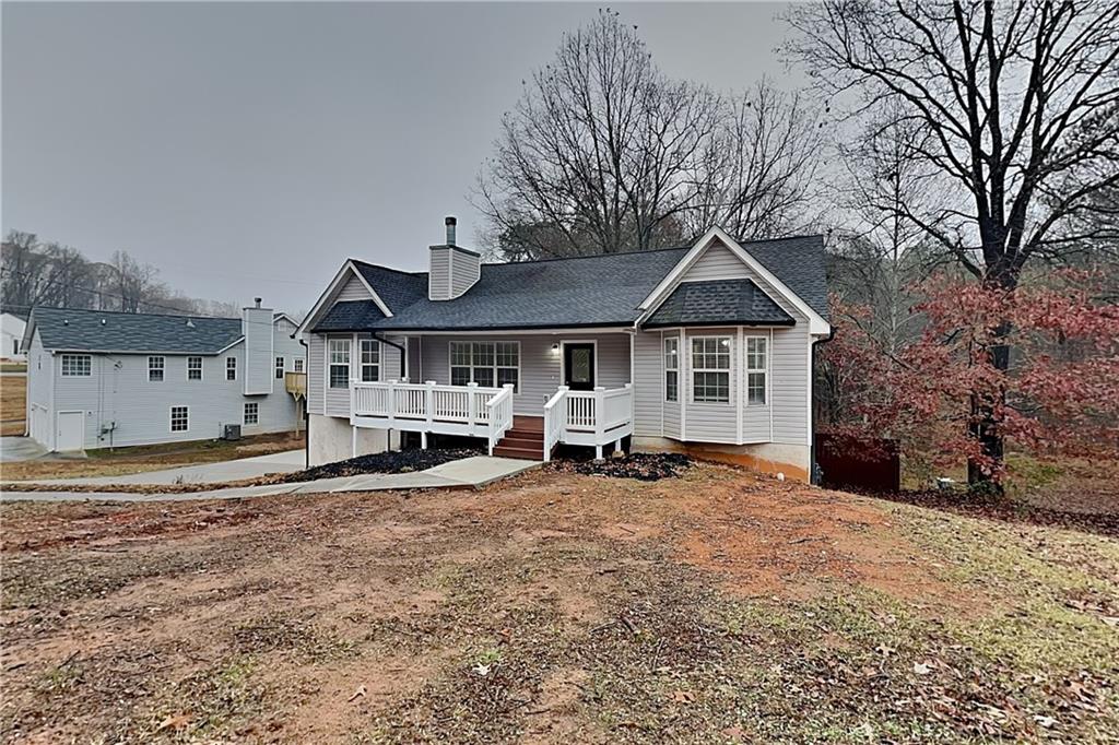 35 Amber Trace Dallas, GA 30132 - Photo 1 of 19 a front view of a house with a yard and large trees