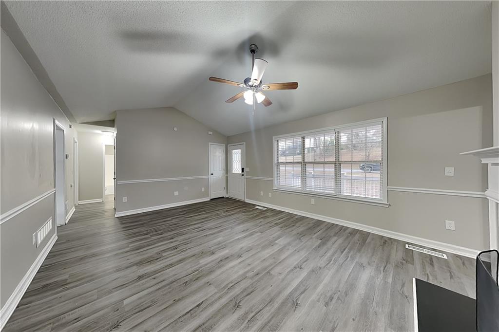35 Amber Trace Dallas, GA 30132 - Photo 2 of 19 a view of an empty room with a window and wooden floor