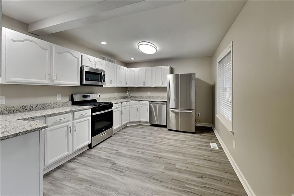 35 Amber Trace Dallas, GA 30132 - Photo 4 of 19 a kitchen with stainless steel appliances granite countertop a refrigerator sink and cabinets