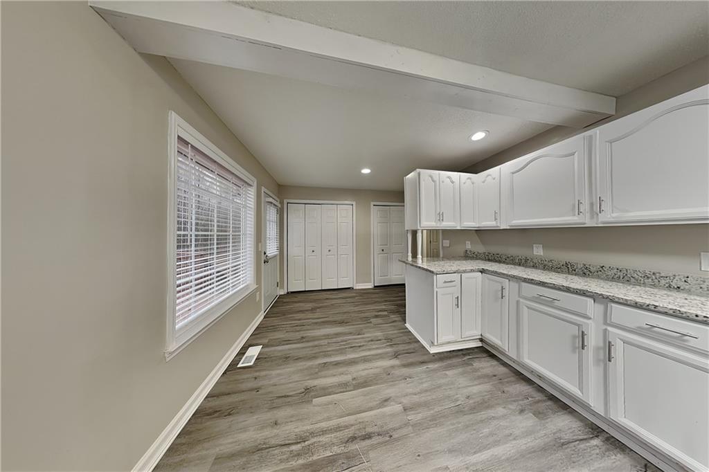 35 Amber Trace Dallas, GA 30132 - Photo 5 of 19 a kitchen with granite countertop white cabinets and white appliances
