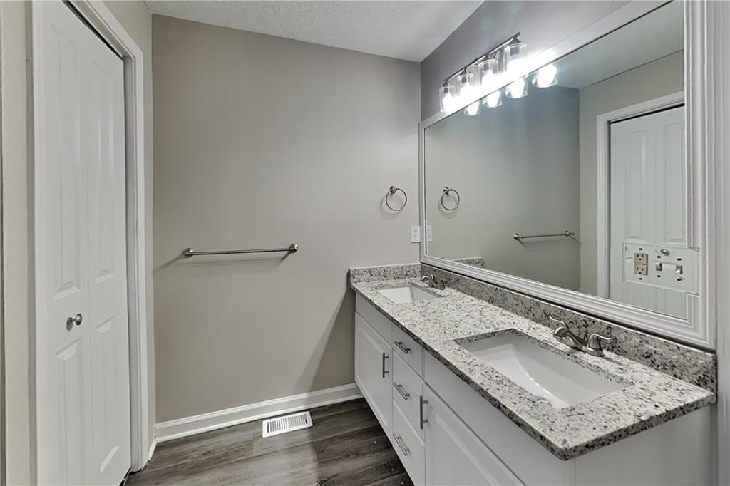 35 Amber Trace Dallas, GA 30132 - Photo 7 of 19 a bathroom with a granite countertop double vanity sink and a mirror