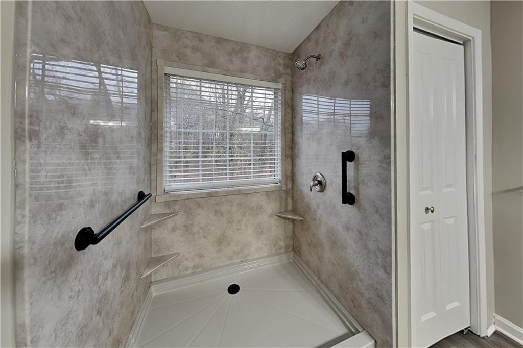 35 Amber Trace Dallas, GA 30132 - Photo 8 of 19 a bathroom with a bathtub and shower