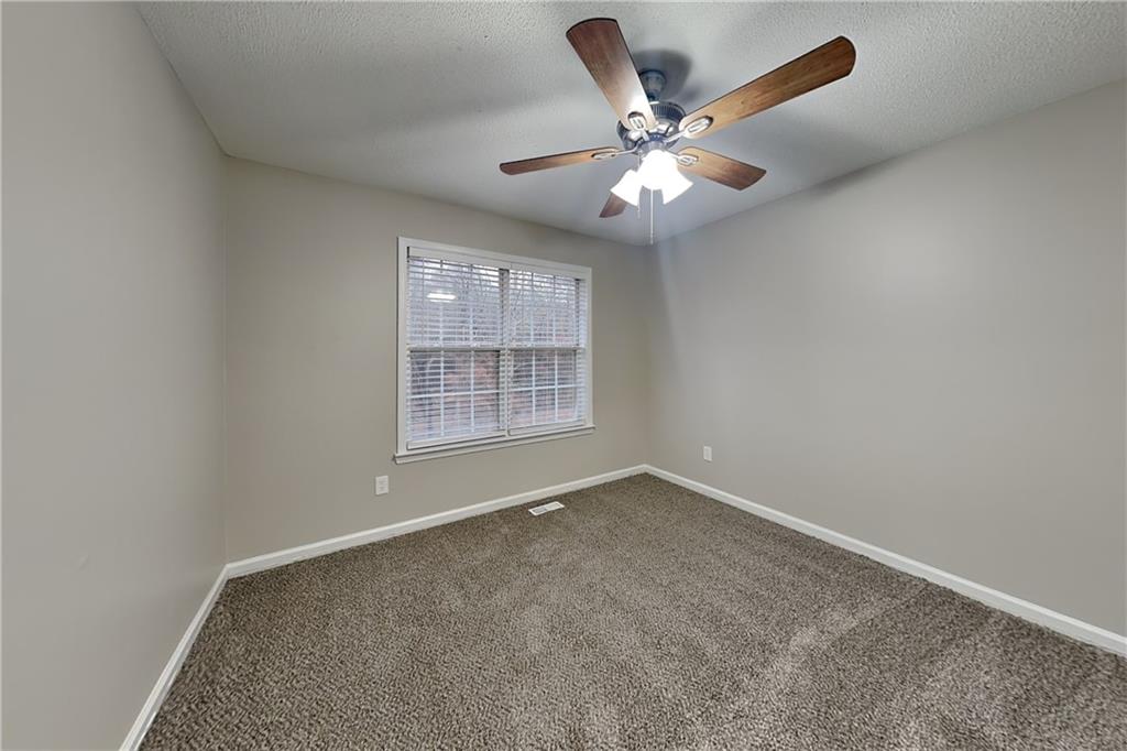 35 Amber Trace Dallas, GA 30132 - Photo 9 of 19 an empty room with windows and fan
