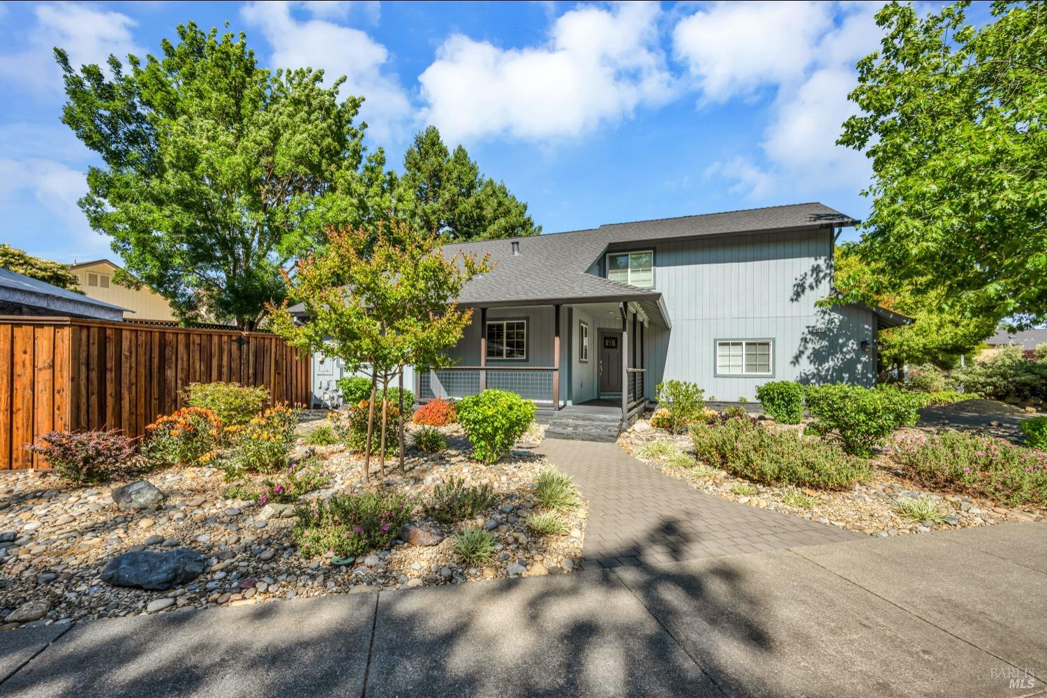 a backyard of a house with table and chairs
