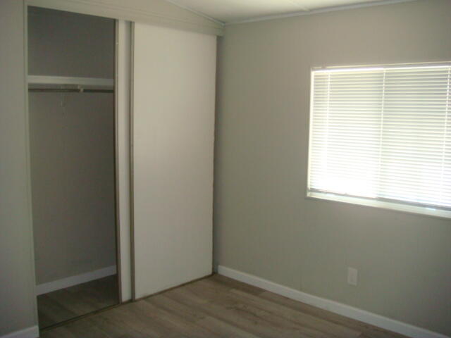 12972 Emerald Drive Whitewater, CA 92282 - Photo 14 of 55 a view of an empty room with wooden floor and a window