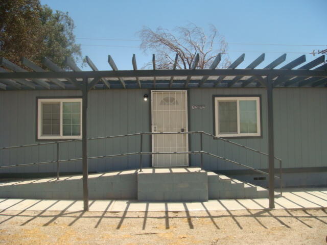 12972 Emerald Drive Whitewater, CA 92282 - Photo 2 of 55 a view of a brick house with a backyard