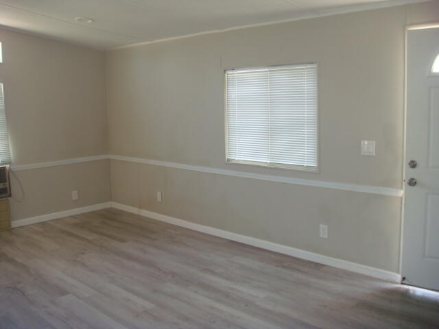 12972 Emerald Drive Whitewater, CA 92282 - Photo 22 of 55 an empty room with wooden floor and windows