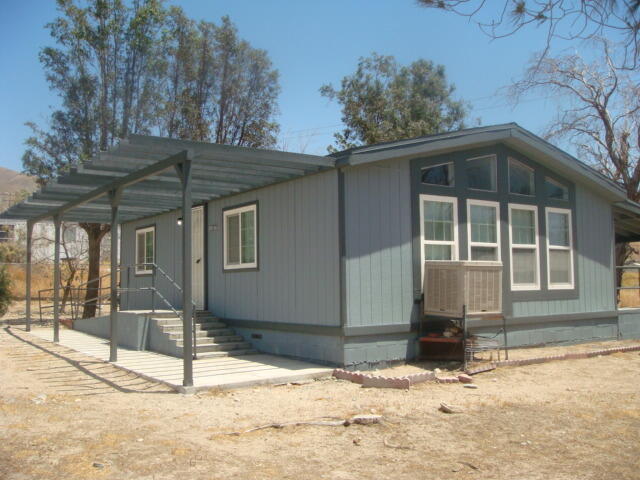 12972 Emerald Drive Whitewater, CA 92282 - Photo 4 of 55 a front view of a house with a yard covered in snow