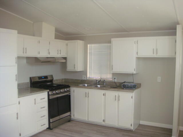 12972 Emerald Drive Whitewater, CA 92282 - Photo 10 of 55 a kitchen with granite countertop a sink a stove and cabinets