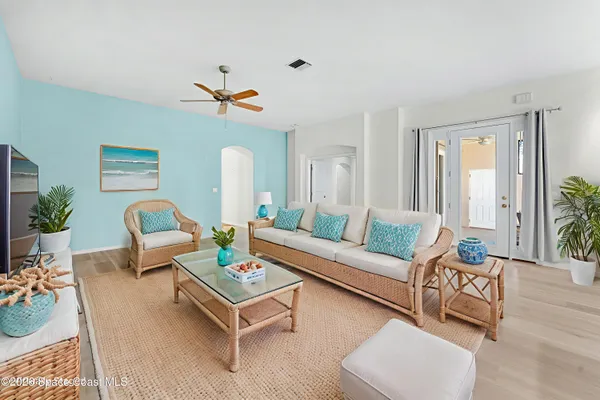 a living room with furniture and wooden floor