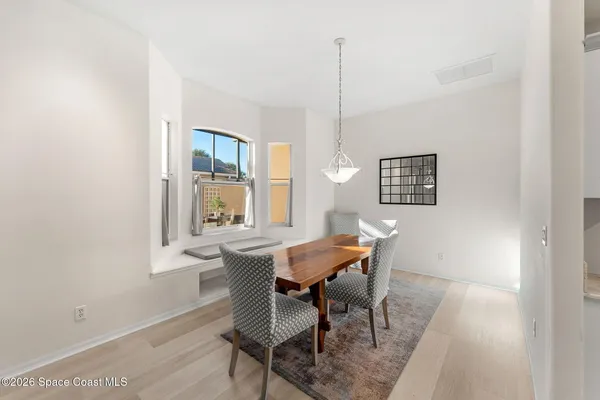 a view of a dining room with furniture and window