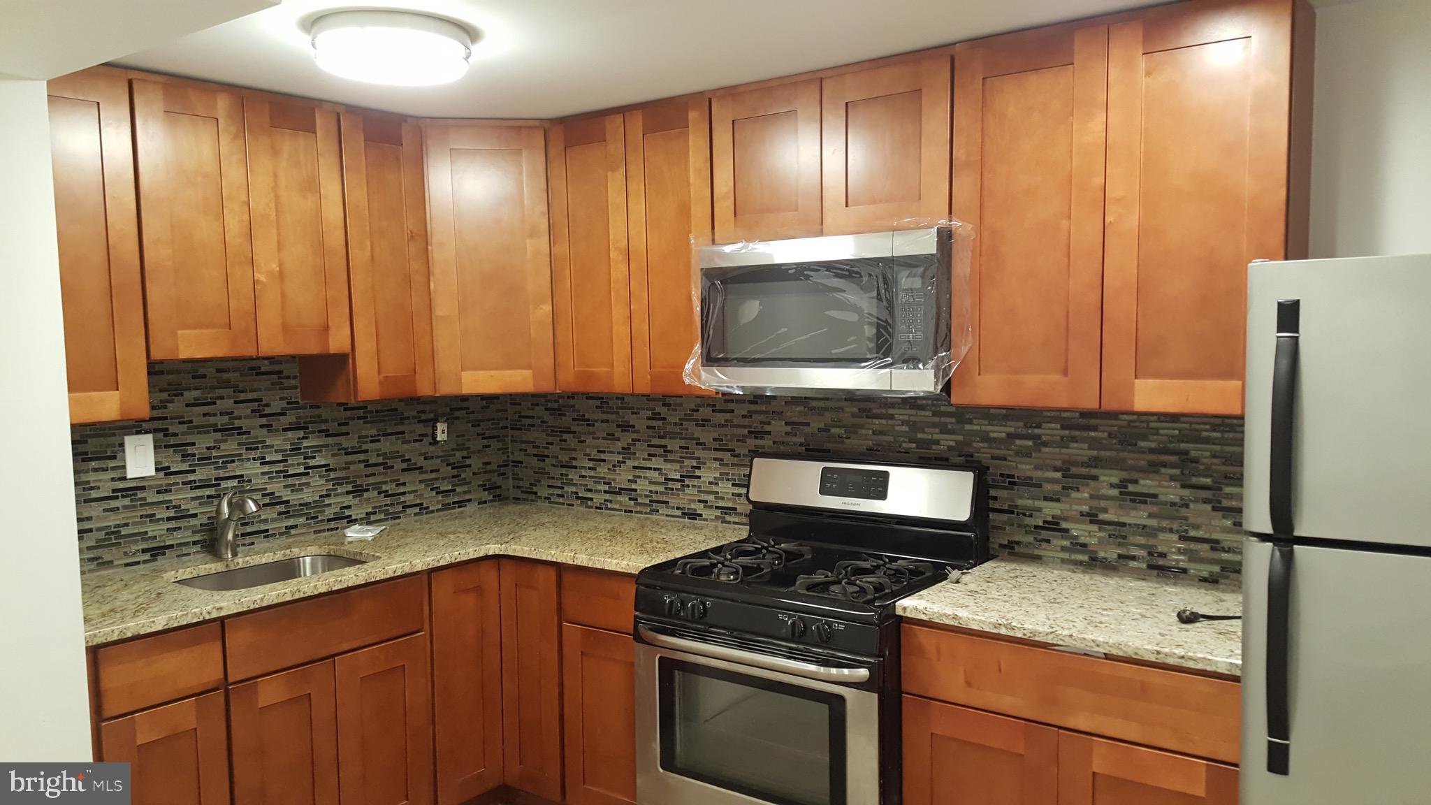 a kitchen with granite countertop cabinets stainless steel appliances and counter space