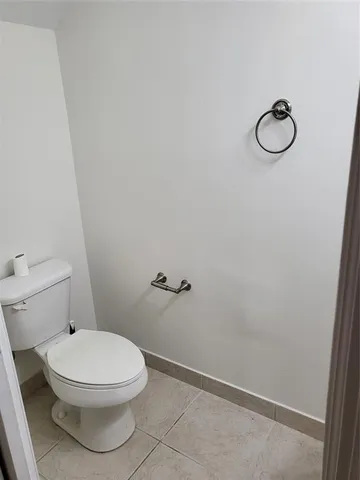 a white toilet and a shower in a bathroom
