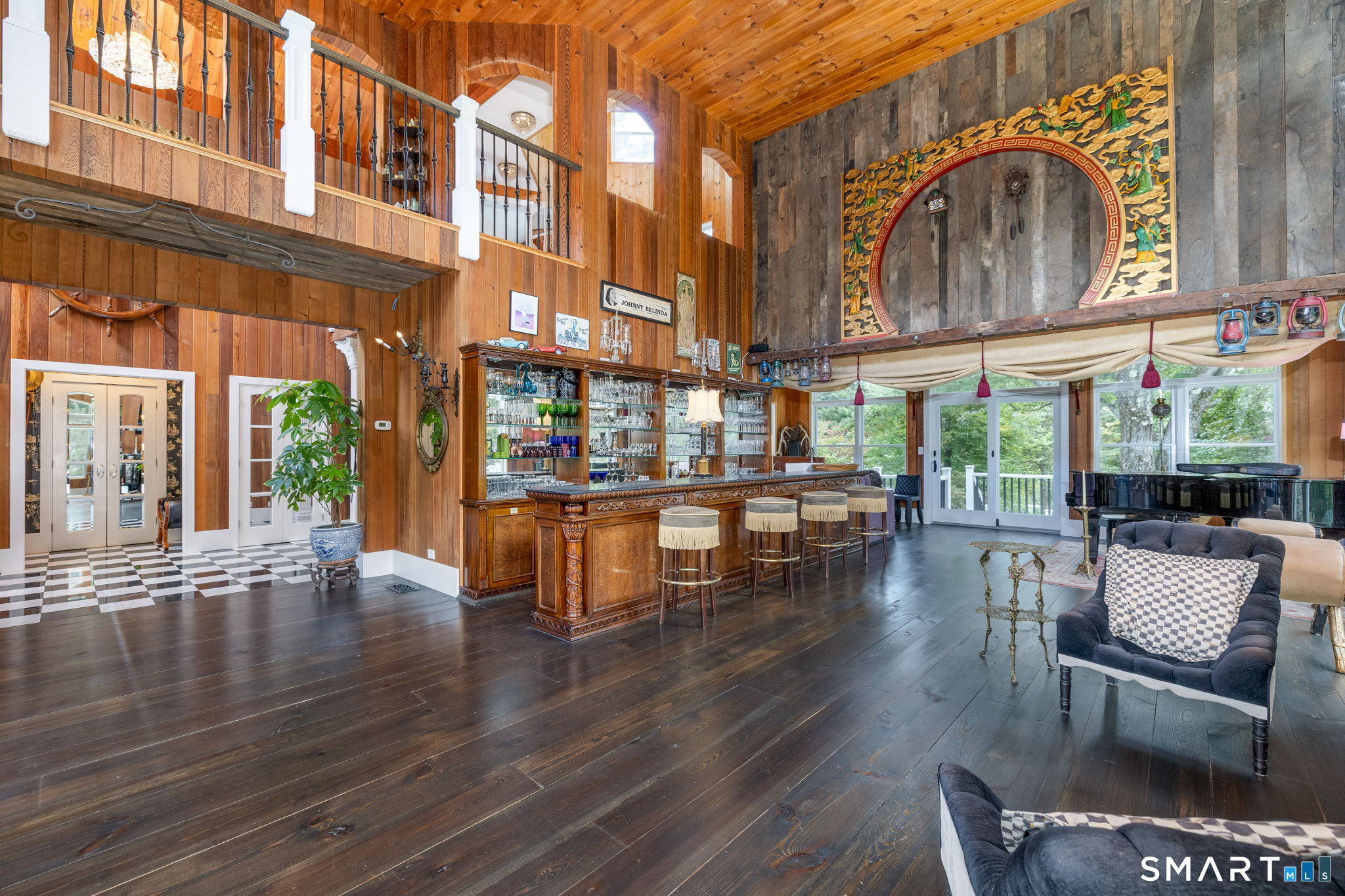 695 Spindle Hill Road Wolcott, CT 06716 - Photo 9 of 40 Double height cathedral ceiling w/ full-scale antique mahogany bar & hand-carved Italian Marble Chimneypiece.
