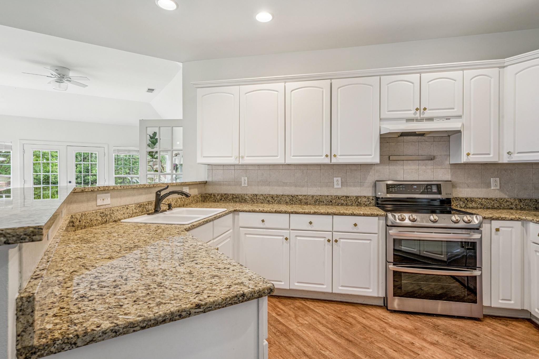 532 Bancroft Way Franklin, TN 37064 - Photo 17 of 48 a kitchen with granite countertop a sink stove and cabinets