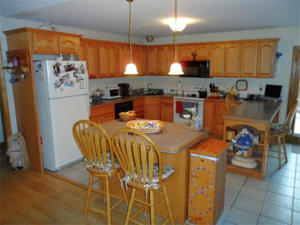 491 Petersham Road Athol, MA 01331 - Photo 4 of 22 a kitchen with stainless steel appliances kitchen island granite countertop a table chairs in it and a window