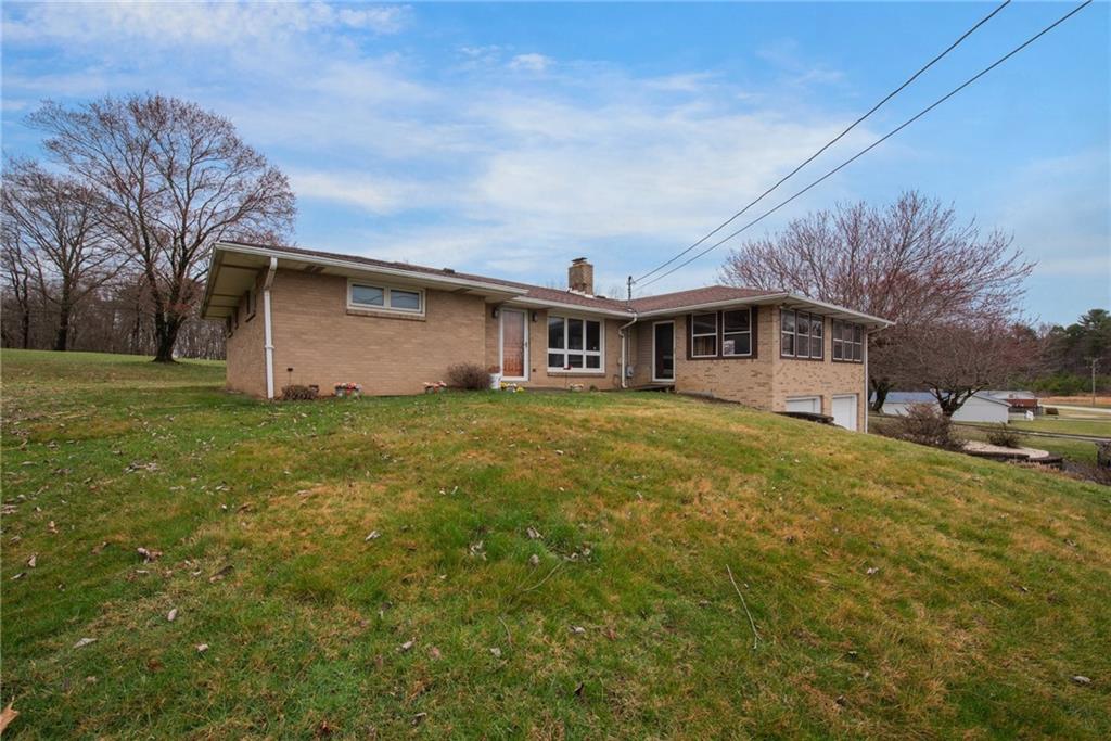 221 Story Road Export, PA 15632 - Photo 2 of 30 a front view of house with yard and trees in the background