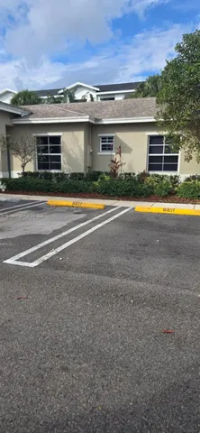 a view of house with a yard