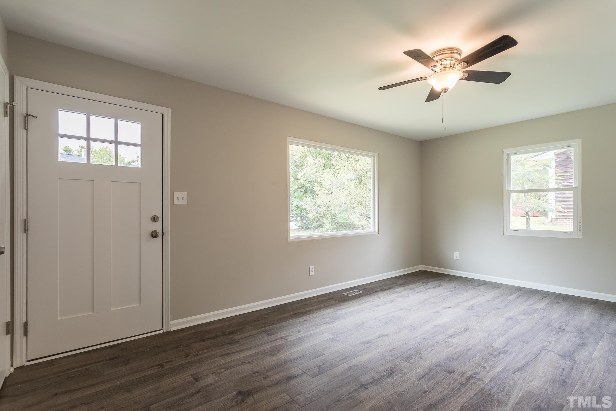 4000 Wheaton Road Durham, NC 27704 - Photo 11 of 21 an empty room with wooden floor and windows