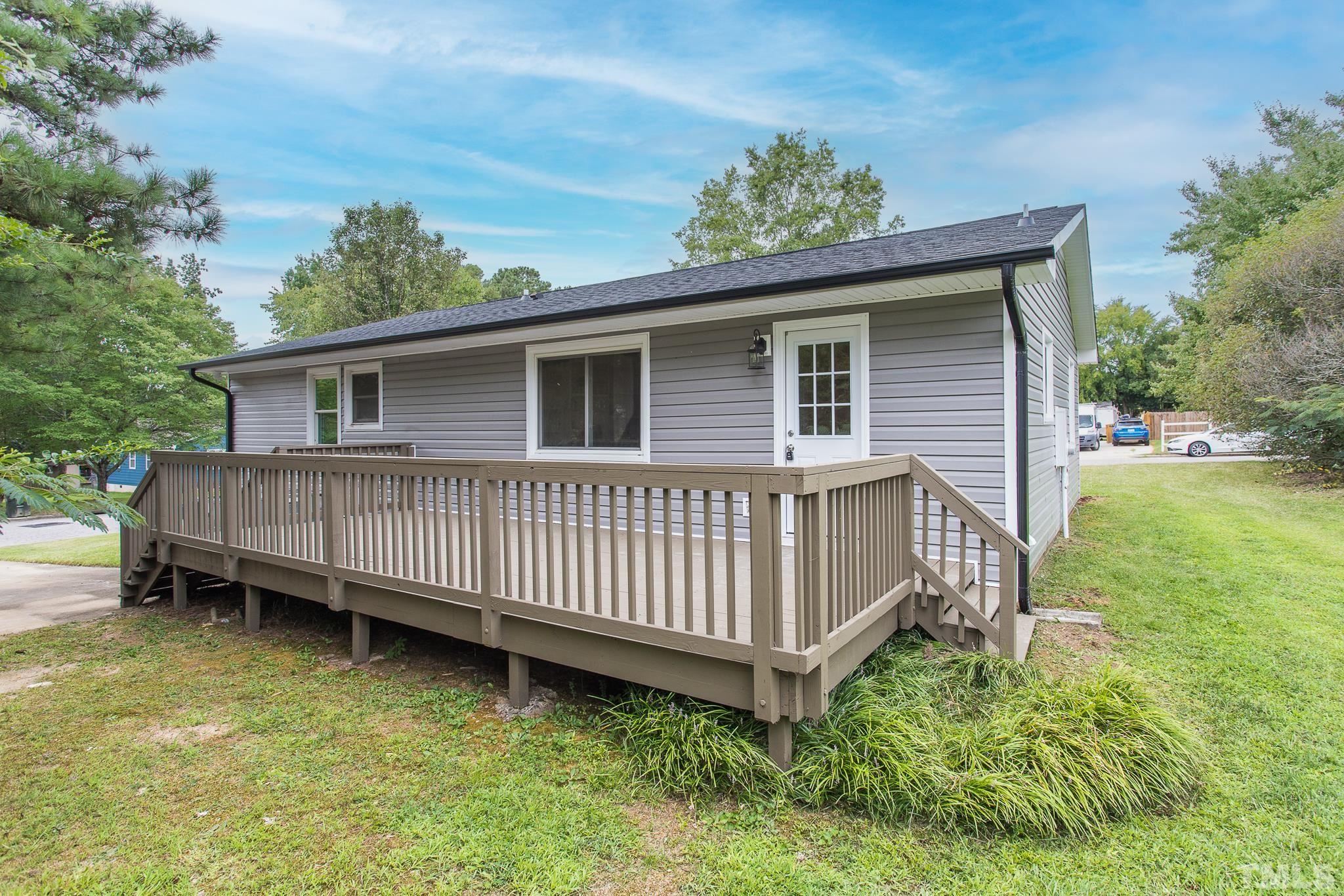 4000 Wheaton Road Durham, NC 27704 - Photo 18 of 21 a view of a house with a backyard and deck