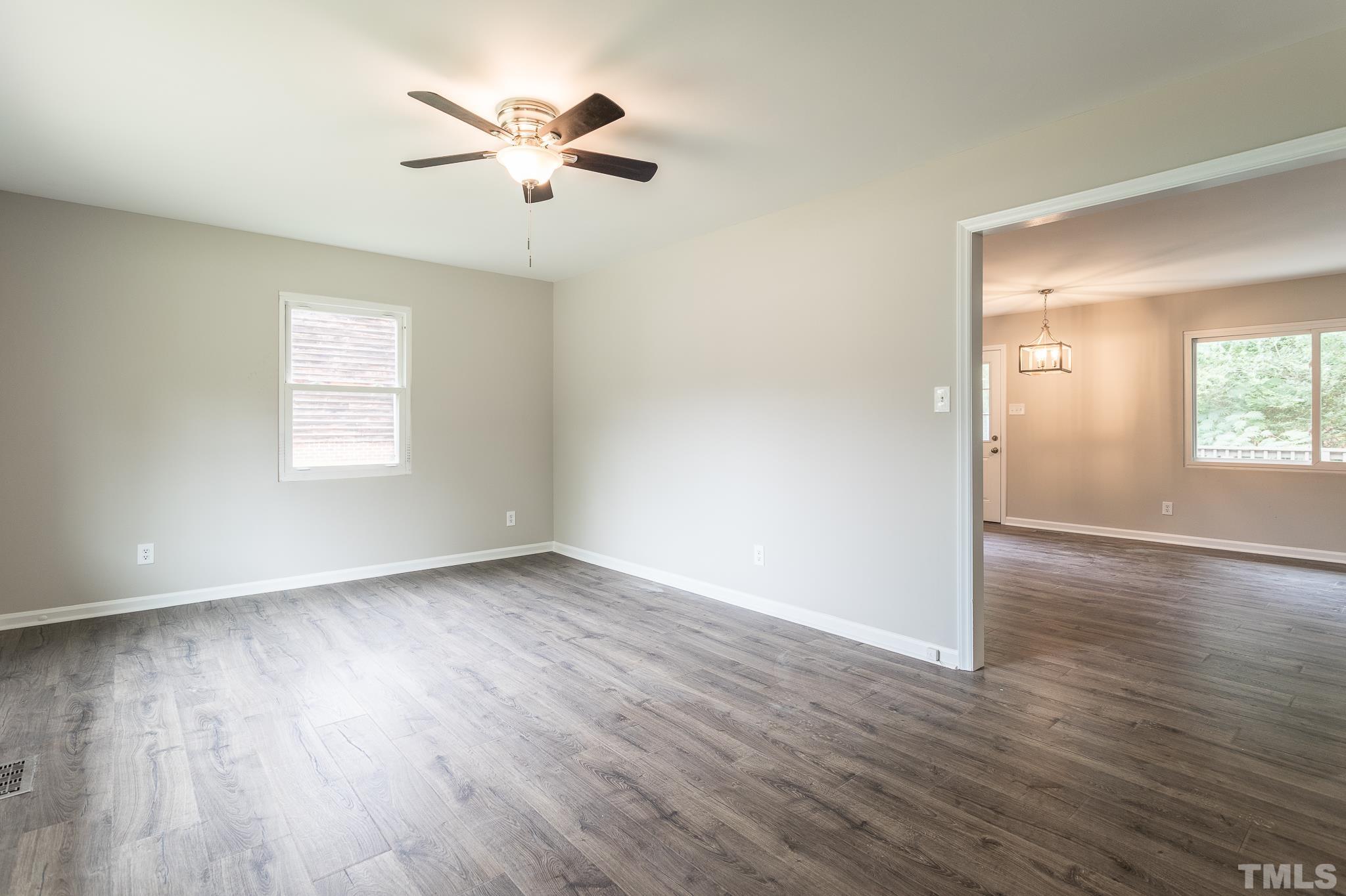 4000 Wheaton Road Durham, NC 27704 - Photo 3 of 21 an empty room with wooden floor and windows