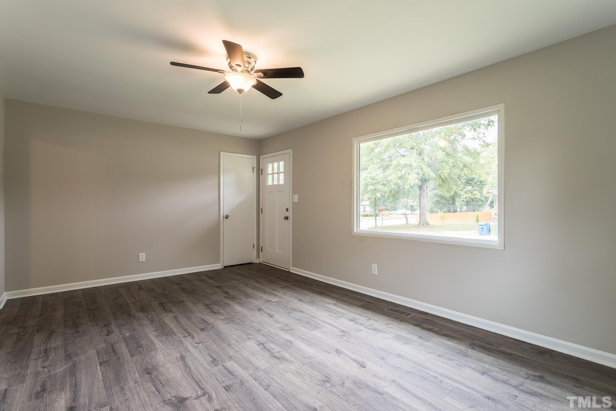 4000 Wheaton Road Durham, NC 27704 - Photo 5 of 21 a view of an empty room with wooden floor and a window