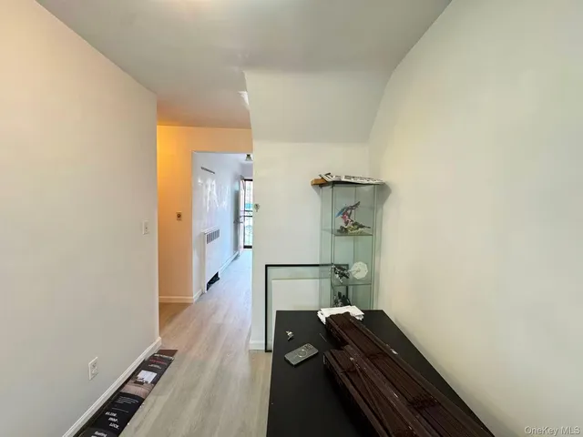 a room with wooden floor and gym equipment