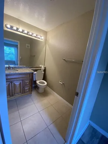 a bathroom with a toilet a sink a mirror and a bathtub