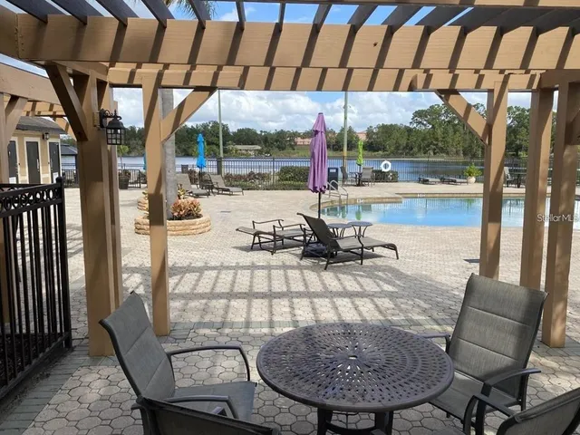 a view of a porch with furniture and a yard