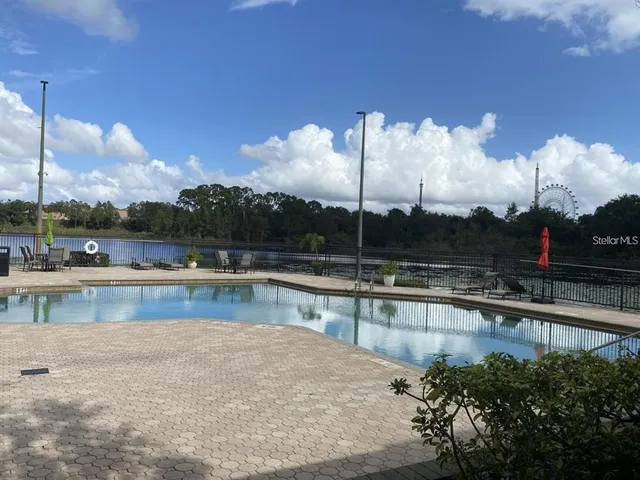 a view of a swimming pool with a lake view and sitting area