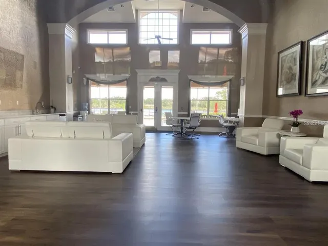 a living room with couches and a large window