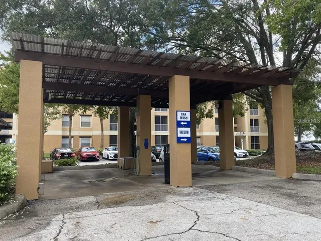 a view of a car park in front of retail shop