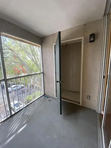 an empty room with sliding door and wooden floor