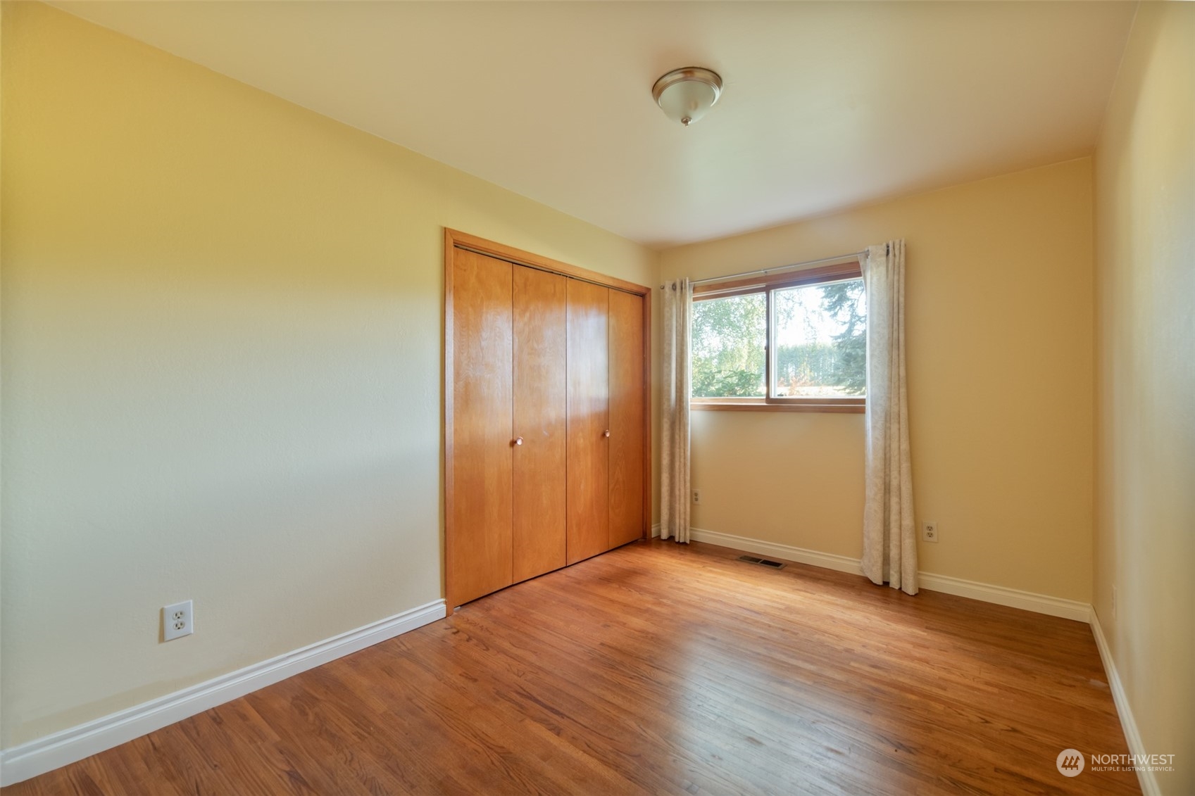 973 Koontz Road Chehalis, WA 98532 - Photo 14 of 25 a view of an empty room with wooden floor and a window