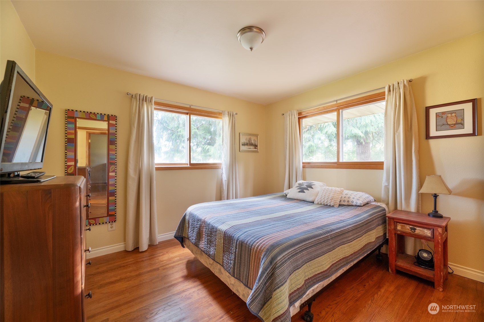 973 Koontz Road Chehalis, WA 98532 - Photo 16 of 25 a bedroom with a bed and wooden floor