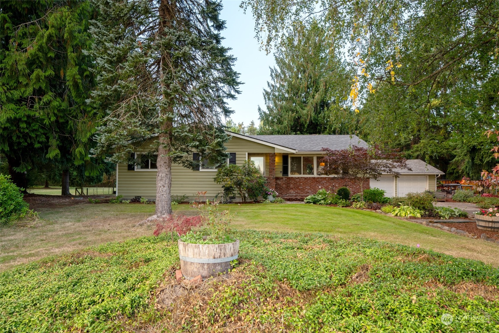 973 Koontz Road Chehalis, WA 98532 - Photo 4 of 25 a front view of a house with a yard and trees