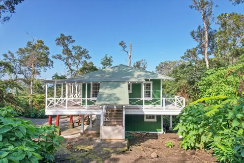 a front view of a house with a garden and patio