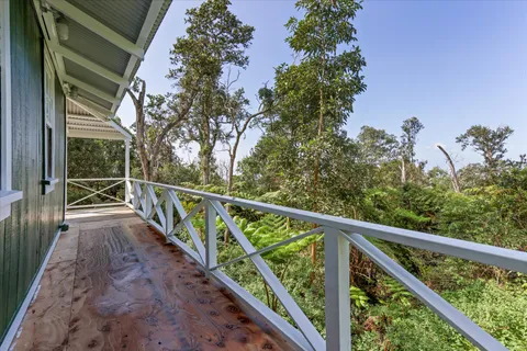 a view of balcony with wooden floor and fence