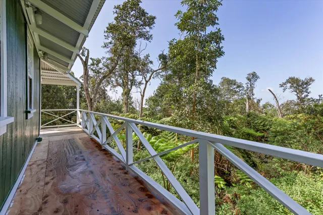 a view of balcony with wooden floor and fence