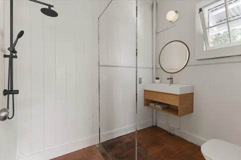 a bathroom with a sink mirror vanity and toilet