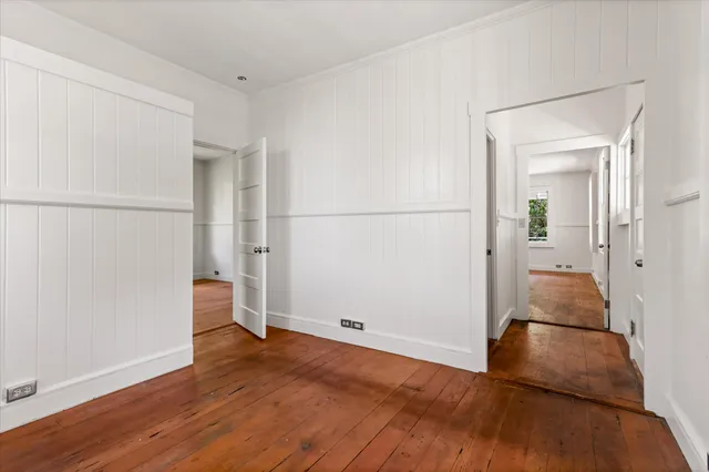 an empty room with wooden floor