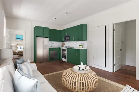 a kitchen with a refrigerator and a couch