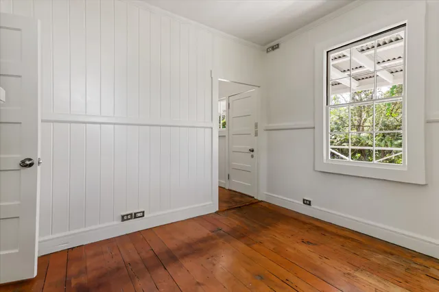 a view of a room with wooden floor and cabinet