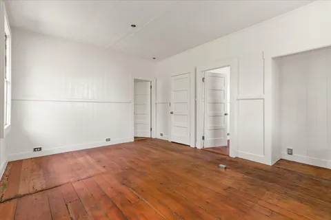 a view of room with wooden floor