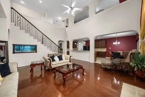a living room with furniture and wooden floor