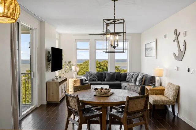 a view of a dining room with furniture a livingroom and chandelier