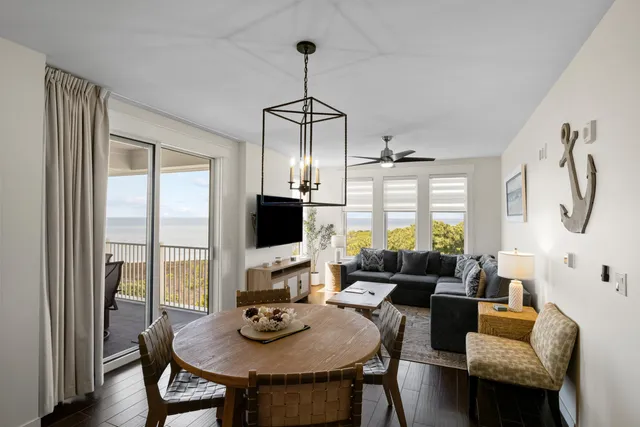 a living room with furniture a flat screen tv and a large window